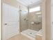 Bathroom featuring a glass shower with a built-in seat and white door at 211 Ibis Ln, Durham, NC 27703