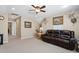 Cozy bonus room with recessed lighting, ceiling fan, and comfortable leather sofa seating at 211 Ibis Ln, Durham, NC 27703