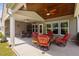 Spacious covered patio with ceiling fan, wooden ceiling, and comfortable seating arrangements at 211 Ibis Ln, Durham, NC 27703