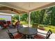 Outdoor patio with ceiling fan, wooden ceiling and outdoor furniture overlooking the backyard at 211 Ibis Ln, Durham, NC 27703