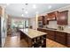 Gourmet kitchen boasts a large island, granite countertops, and wood cabinetry at 211 Ibis Ln, Durham, NC 27703