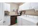 Laundry room with white cabinets and countertops, plus a washer and dryer at 211 Ibis Ln, Durham, NC 27703