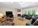 Bright living room with fireplace, large windows, and comfortable seating at 211 Ibis Ln, Durham, NC 27703