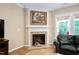 Cozy living room features a fireplace with stone surround and a view of the backyard at 211 Ibis Ln, Durham, NC 27703