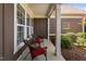 Side porch features seating and views of lush plantings at 211 Ibis Ln, Durham, NC 27703