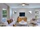 Cozy living room featuring a stylish sofa, armchair, and large windows at 215 Blue Butterfly Dr, Angier, NC 27501