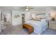 Spacious main bedroom with a decorative accent wall, king bed, bench, and walk-in closet access at 215 Blue Butterfly Dr, Angier, NC 27501