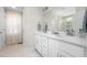Bright bathroom featuring double sinks, white cabinets, tile flooring and modern fixtures at 220 Purslane Dr, Franklinton, NC 27525