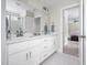 Bright bathroom featuring double sinks, white cabinets, tile flooring and modern fixtures at 220 Purslane Dr, Franklinton, NC 27525