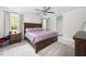 Comfortable bedroom featuring soft carpet, a ceiling fan, and a large bed with side tables at 220 Purslane Dr, Franklinton, NC 27525