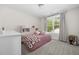 Charming bedroom with a cozy bed, large window, and soft natural light at 220 Purslane Dr, Franklinton, NC 27525