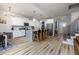 Open floor plan showing the kitchen with white cabinets, granite countertops, stainless appliances, and island seating at 220 Purslane Dr, Franklinton, NC 27525