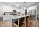 Bright kitchen with stainless steel appliances, white cabinets, and a large island with seating at 220 Purslane Dr, Franklinton, NC 27525