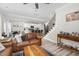 Open living room with connected kitchen, hardwood flooring, and stairs to the upper level at 220 Purslane Dr, Franklinton, NC 27525