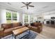 Open living room with hardwood flooring, views of the dining room and kitchen and access to a deck at 220 Purslane Dr, Franklinton, NC 27525