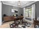 Stylish office with hardwood floors, gray walls, large window, desk and cowhide rug at 220 Purslane Dr, Franklinton, NC 27525