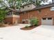 Brick house rear exterior featuring a patio and garage at 2228 Walker Ave, Burlington, NC 27215