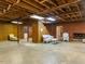 Spacious basement features wood paneling and exposed ceiling beams at 2228 Walker Ave, Burlington, NC 27215