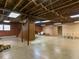 Unfinished basement featuring brick accents, exposed beams, and concrete floors, offering potential for customization at 2228 Walker Ave, Burlington, NC 27215