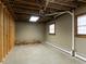 Unfinished basement featuring painted brick walls, exposed ductwork, and potential for storage or customization at 2228 Walker Ave, Burlington, NC 27215
