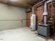 Basement with utility area with water heater, furnace and brick walls at 2228 Walker Ave, Burlington, NC 27215