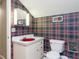 Bathroom featuring a quirky red sink, patterned wallpaper, and bright vanity lighting at 2228 Walker Ave, Burlington, NC 27215