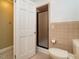 Cozy bathroom featuring a walk-in shower, toilet, and a door at 2228 Walker Ave, Burlington, NC 27215