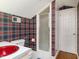 Bathroom featuring a quirky red sink, walk in shower, and patterned wallpaper at 2228 Walker Ave, Burlington, NC 27215