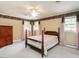 Bedroom with four-poster bed, neutral walls, and bright windows at 2228 Walker Ave, Burlington, NC 27215