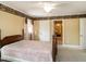 Bedroom with four-poster bed, neutral walls, and bright windows at 2228 Walker Ave, Burlington, NC 27215