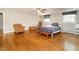 Large bedroom features a sitting area and gleaming hardwood floors at 2228 Walker Ave, Burlington, NC 27215