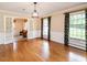 Formal dining room features hardwood floors, wainscoting, and large windows with elegant draperies at 2228 Walker Ave, Burlington, NC 27215
