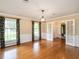 Formal dining room features hardwood floors, wainscoting, and large windows with elegant draperies at 2228 Walker Ave, Burlington, NC 27215