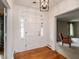 Bright foyer with hardwood floors features a white front door with sidelights and transom window at 2228 Walker Ave, Burlington, NC 27215