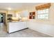 Spacious kitchen features white cabinetry, stainless appliances, and a breakfast bar for casual dining at 2228 Walker Ave, Burlington, NC 27215