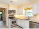 Well-equipped kitchen features stainless steel appliances, including a gas range and built-in microwave at 2228 Walker Ave, Burlington, NC 27215
