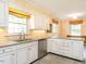 Bright kitchen with white cabinets, tiled backsplash, stainless steel appliances, and stone countertops at 2228 Walker Ave, Burlington, NC 27215