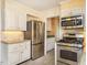 Modern kitchen with stainless steel appliances, white cabinets, and ample counter space for cooking at 2228 Walker Ave, Burlington, NC 27215