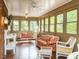 Charming sunroom with multiple windows, brick accents, and comfortable seating at 2228 Walker Ave, Burlington, NC 27215