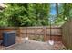 Cozy backyard features a wood fence for privacy and string lights for ambiance at 2233 Alpine Rd, Durham, NC 27707