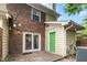 Backyard patio features a brick and siding exterior and sliding glass doors at 2233 Alpine Rd, Durham, NC 27707