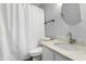 Bathroom featuring a shower and tub combo with updated sink, vanity, toilet and brushed metal finishes at 2233 Alpine Rd, Durham, NC 27707