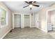 Bedroom with wood-look floors, ceiling fan, attached bathroom, and double closets at 2233 Alpine Rd, Durham, NC 27707