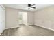 Bedroom with wood-look floors, ceiling fan, a window and an accent wall at 2233 Alpine Rd, Durham, NC 27707