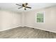 Bedroom with a ceiling fan, wood-look floors and a window to let in natural lighting at 2233 Alpine Rd, Durham, NC 27707