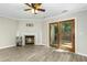 Inviting living room featuring wood floors, fireplace, fan and access to backyard at 2233 Alpine Rd, Durham, NC 27707