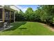 Beautifully landscaped backyard with a patio, outdoor seating, and lush green grass at 2361 Rainy Lake St, Wake Forest, NC 27587