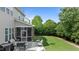 Well-maintained backyard with lush lawn, mature trees, patio, and screened porch at 2361 Rainy Lake St, Wake Forest, NC 27587