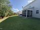 Expansive backyard with a screened porch, a patio, and a lush green lawn at 2361 Rainy Lake St, Wake Forest, NC 27587