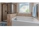 Bathroom features a soaking tub with black hardware and decorative window at 2361 Rainy Lake St, Wake Forest, NC 27587